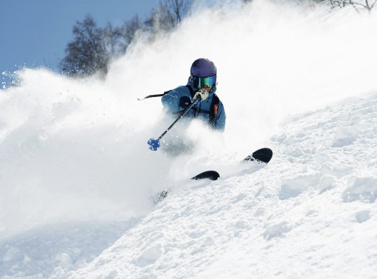Male skier swerve skiing down mountain, Alpe-d'Huez, Rhone-Alpes, France